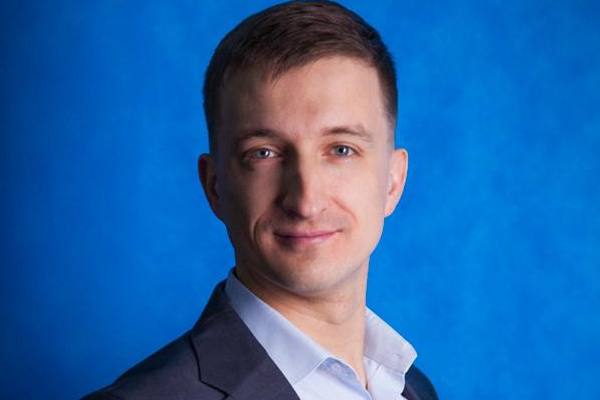 Портрет Артема Хомышина, нового коммерческого директора группы компаний «Ориентир», на синем фоне
