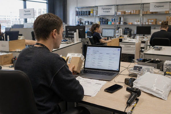 Сотрудник e-commerce-ритейлера проверяет трансграничный заказ электроники в офисной зоне маркетплейса