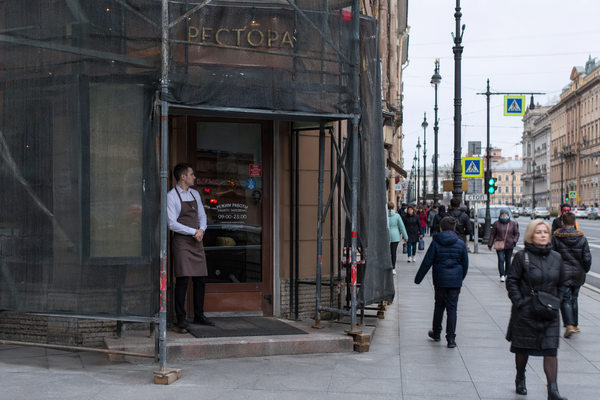 Ресторан в центре Санкт-Петербурга закрыт строительными лесами, сниженный пешеходный трафик у входа, влияние ремонта фасадов на стрит-ритейл