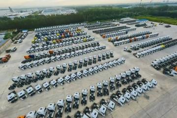 Площадка с сотнями новых грузовиков SINOTRUK, выстроенных рядами перед отправкой на экспорт